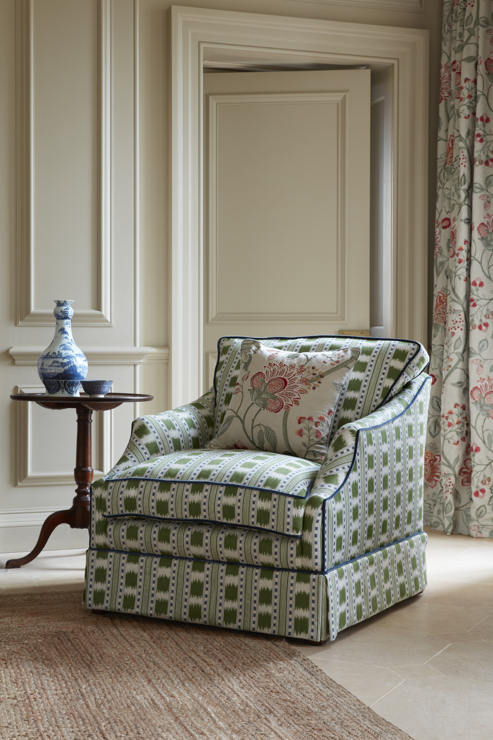 Image of upholstered armchair in greens and blues.